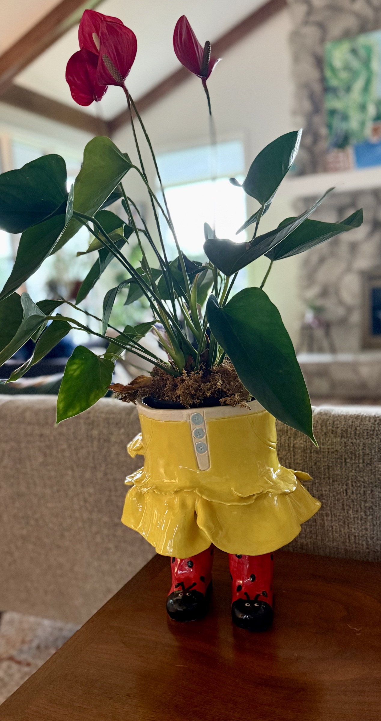 Garden Lily, a figure in a ruffled yellow skirt standing in red ladybird boots